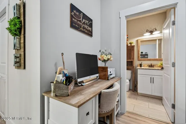 an aerial view of residential houses with outdoor space and trees