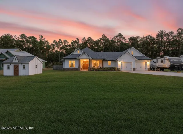 a house with green field in front of it