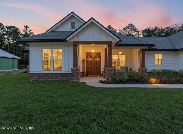 a front view of a house with a yard and porch