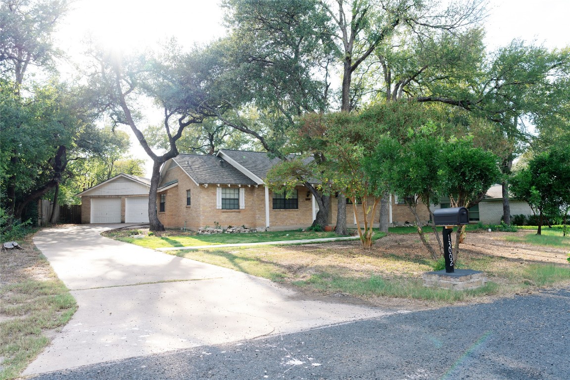 13002 Cedarhurst Circle Austin, TX 78729 - Photo 2 of 40 a house with a tree in front of it
