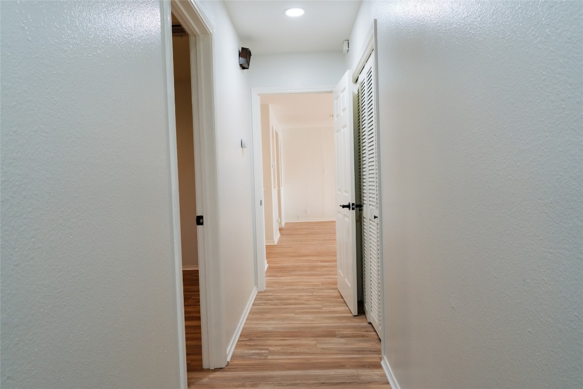 13002 Cedarhurst Circle Austin, TX 78729 - Photo 23 of 40 a view of a hallway with wooden floor and staircase