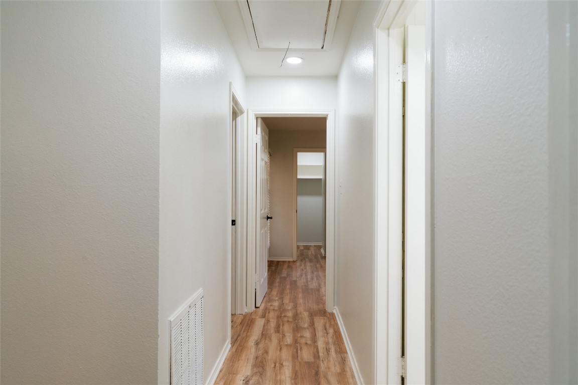 13002 Cedarhurst Circle Austin, TX 78729 - Photo 26 of 40 a view of a hallway with wooden floor and closet