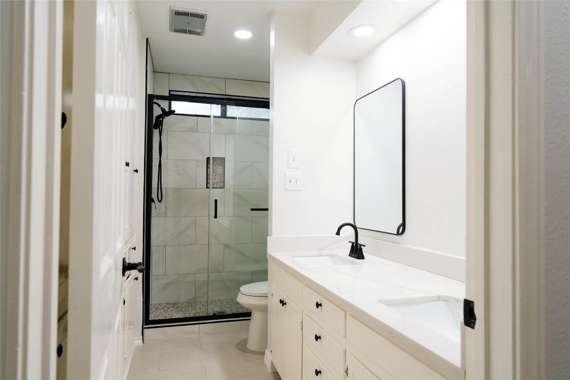 13002 Cedarhurst Circle Austin, TX 78729 - Photo 27 of 40 a bathroom with a shower sink and mirror