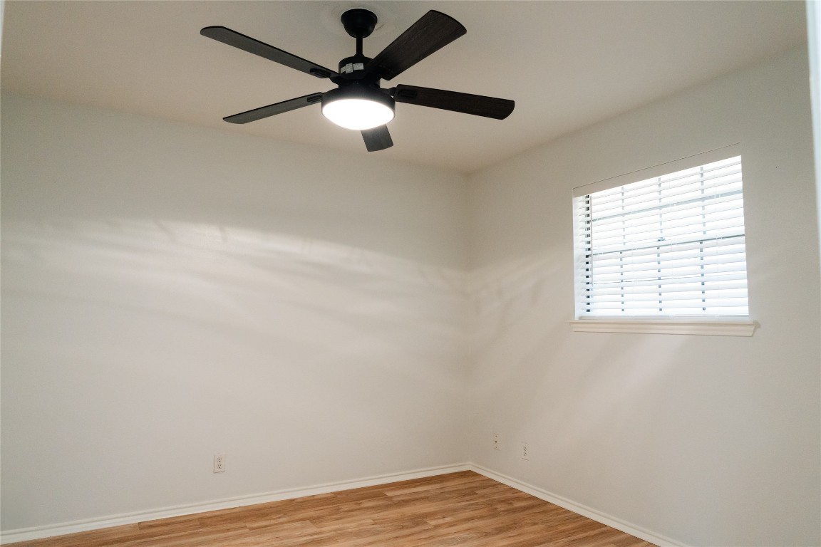 13002 Cedarhurst Circle Austin, TX 78729 - Photo 29 of 40 an empty room with wooden floor and windows