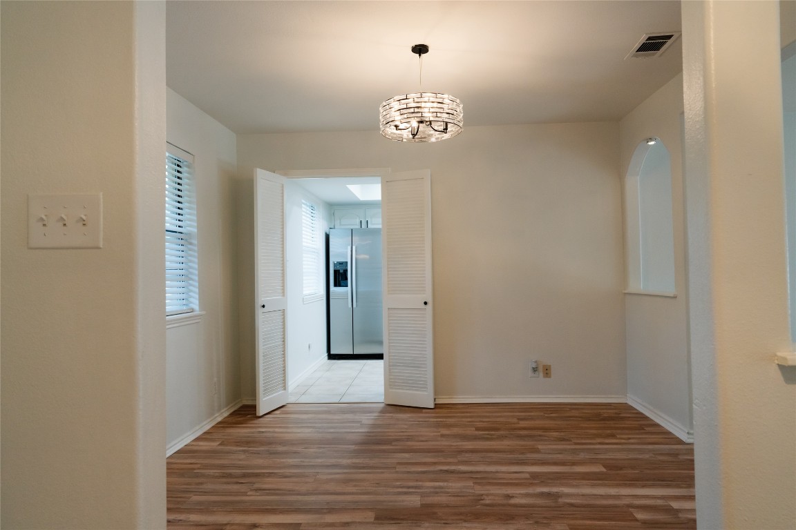 13002 Cedarhurst Circle Austin, TX 78729 - Photo 9 of 40 a view of a hallway with a chandelier
