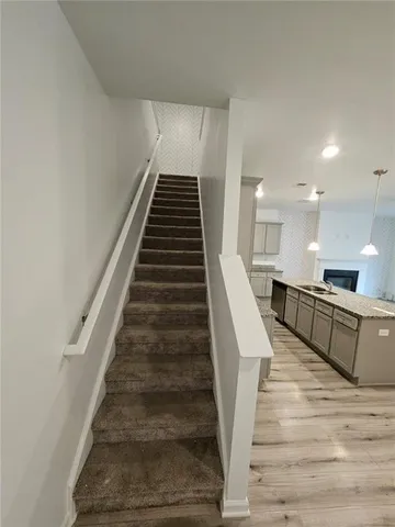 a view of a kitchen with wooden floor and electronic appliances