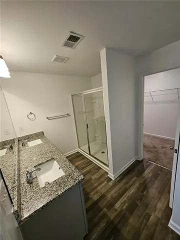 a bathroom with a granite countertop sink and a mirror