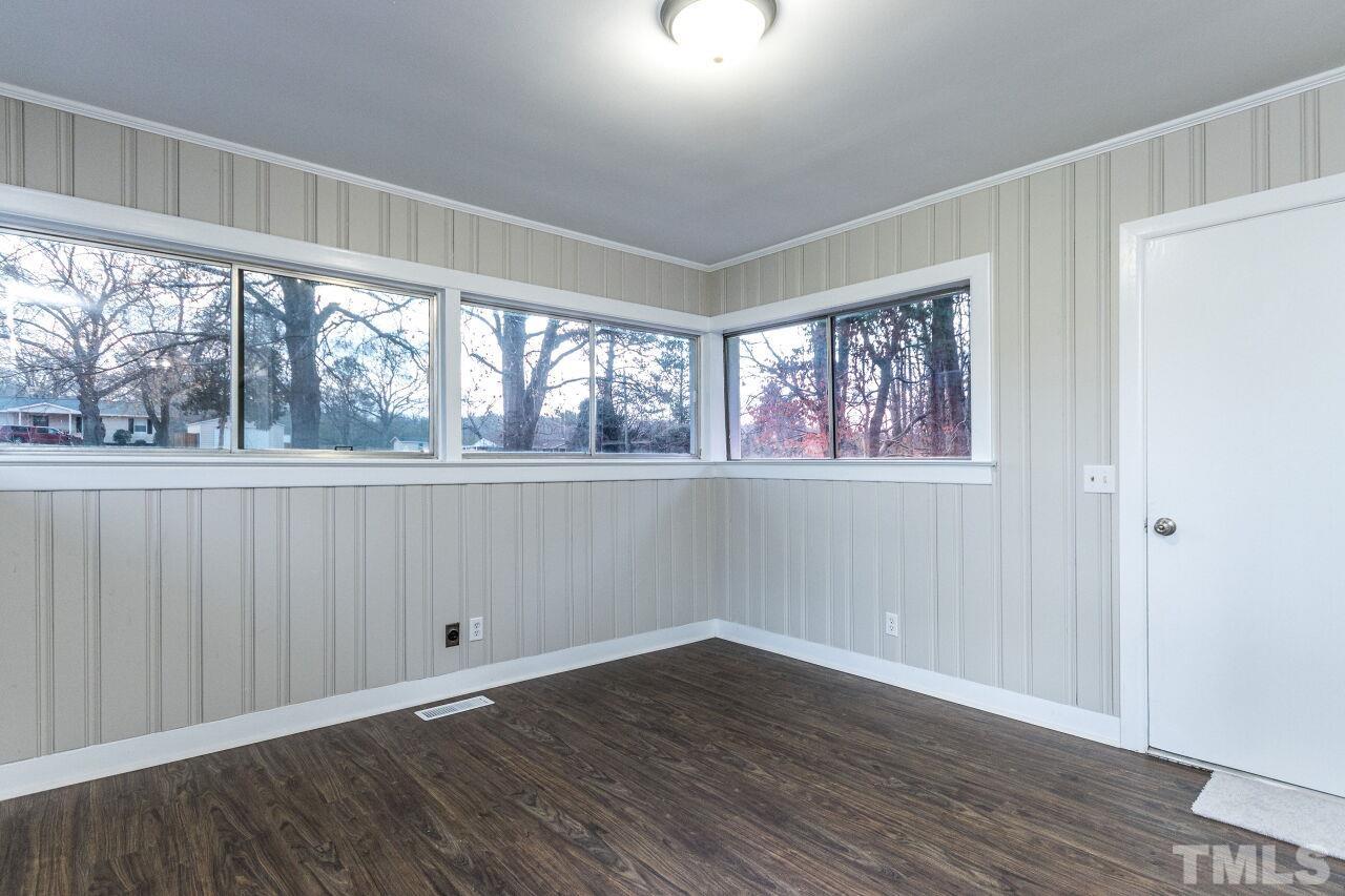 1309 Legend Road Raleigh, NC 27603 - Photo 13 of 27 an empty room with wooden floor and windows