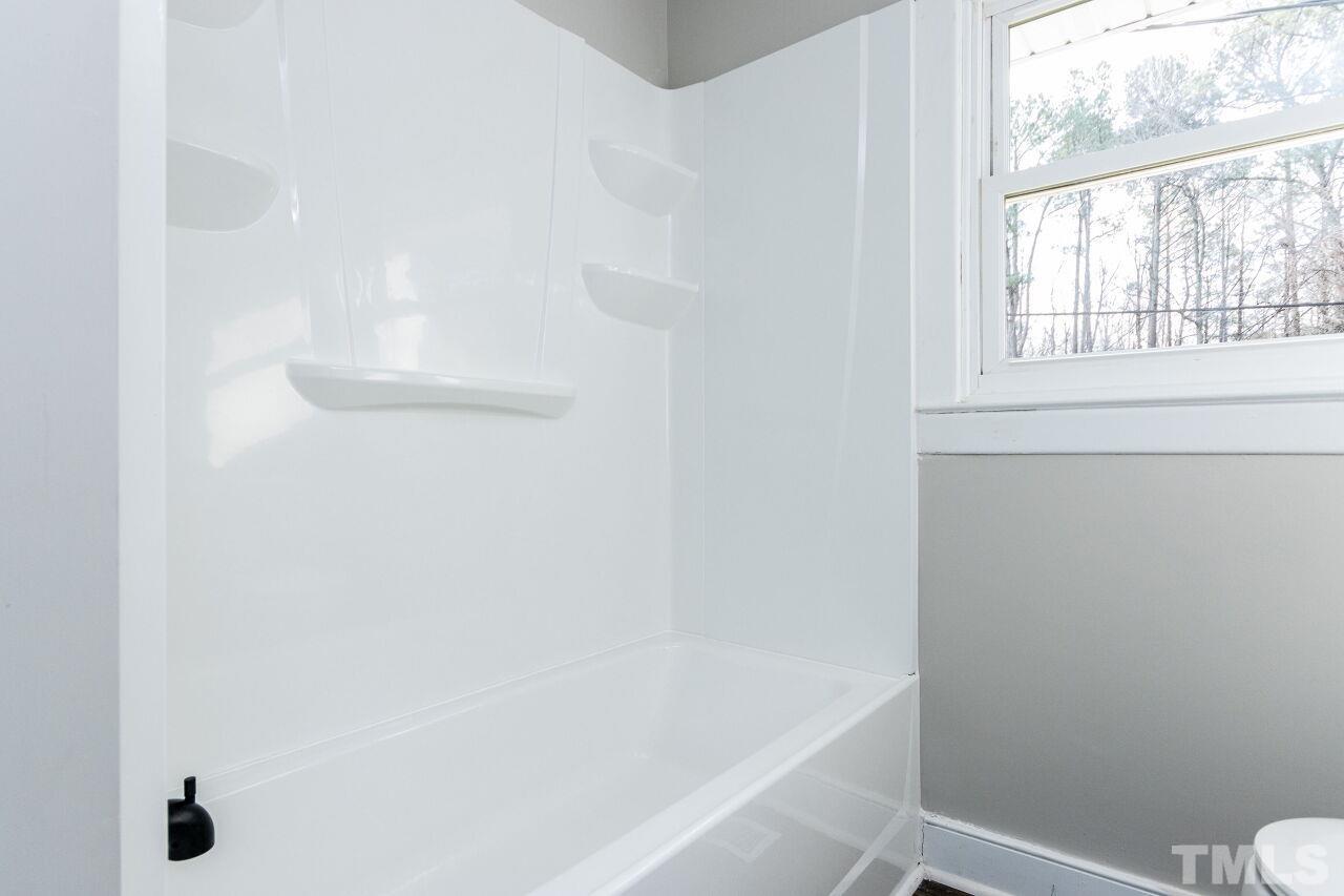 1309 Legend Road Raleigh, NC 27603 - Photo 19 of 27 a bathroom with a bathtub and window