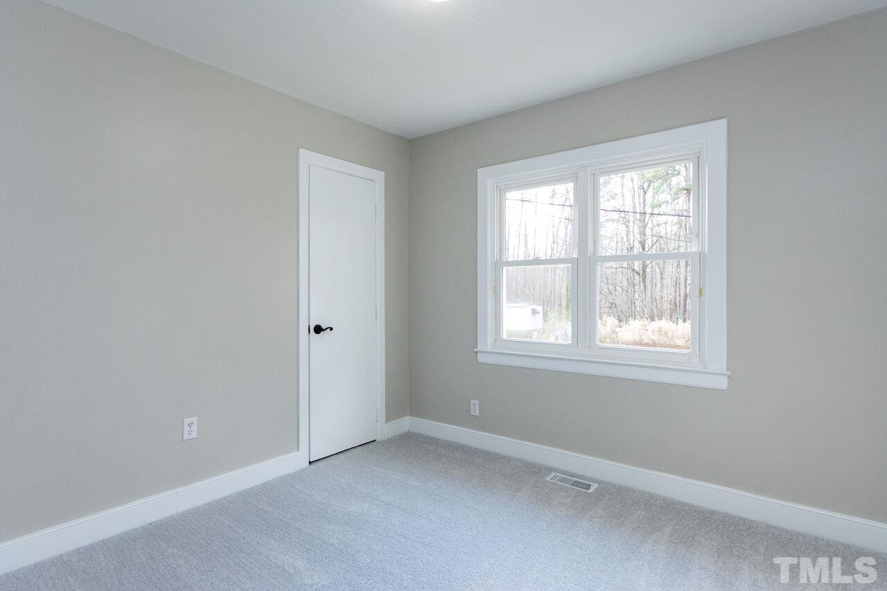 1309 Legend Road Raleigh, NC 27603 - Photo 20 of 27 an empty room with a window