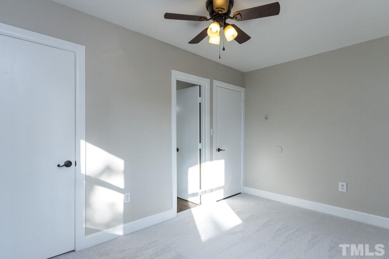 1309 Legend Road Raleigh, NC 27603 - Photo 23 of 27 a view of an empty room and chandelier fan
