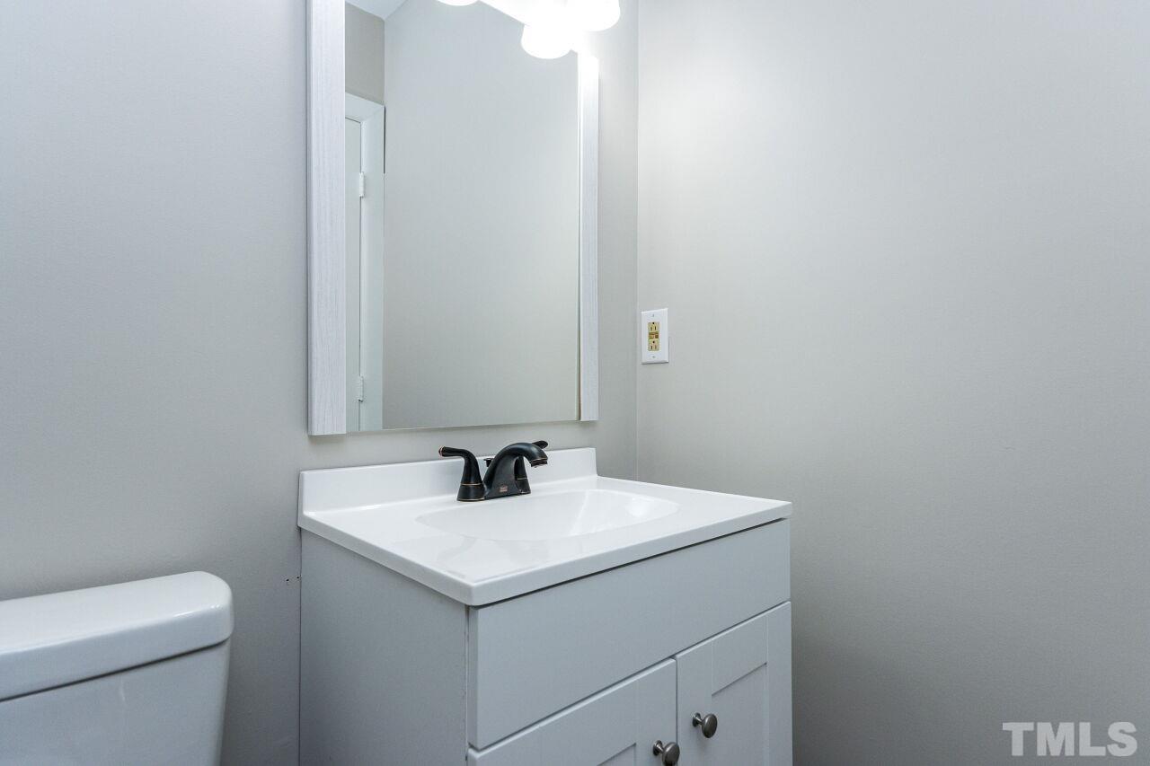 1309 Legend Road Raleigh, NC 27603 - Photo 24 of 27 a bathroom with a sink and a toilet