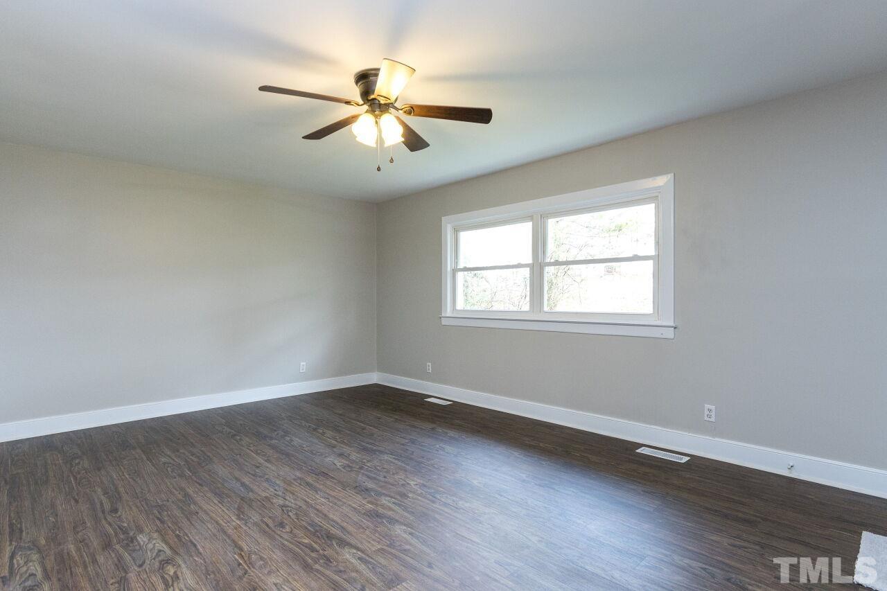 1309 Legend Road Raleigh, NC 27603 - Photo 5 of 27 a view of a room with wooden floor and windows