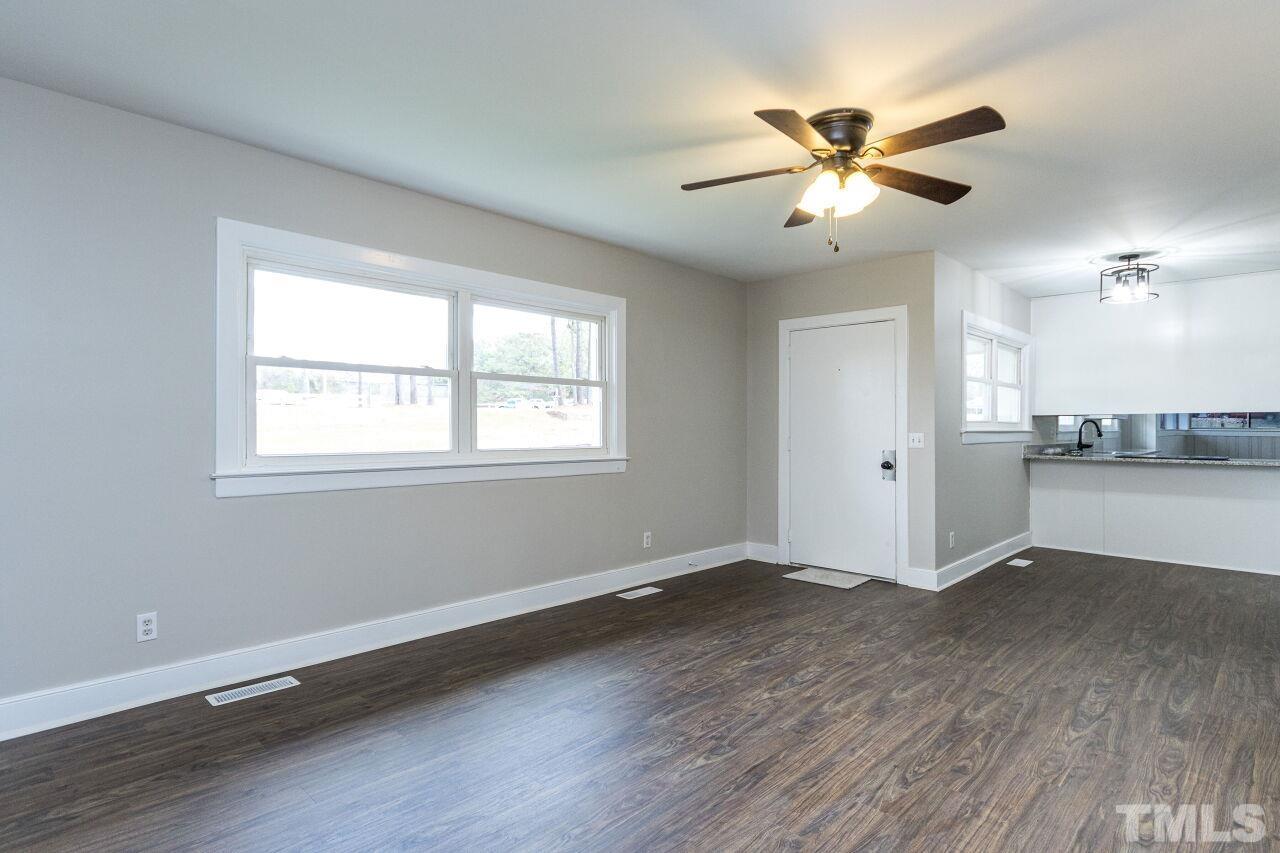 1309 Legend Road Raleigh, NC 27603 - Photo 6 of 27 a view of an empty room with wooden floor and a window