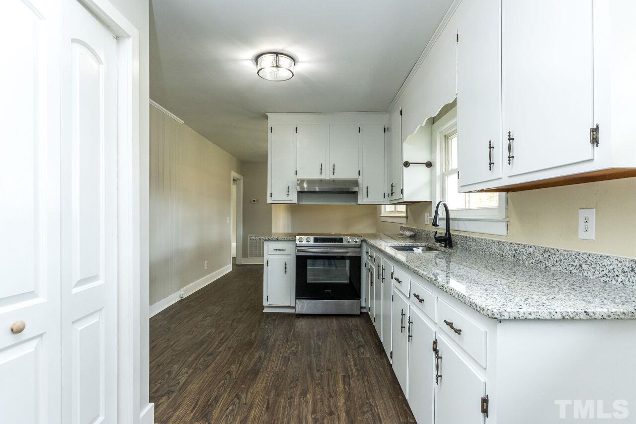 1309 Legend Road Raleigh, NC 27603 - Photo 10 of 27 a kitchen with stainless steel appliances granite countertop a stove and a sink