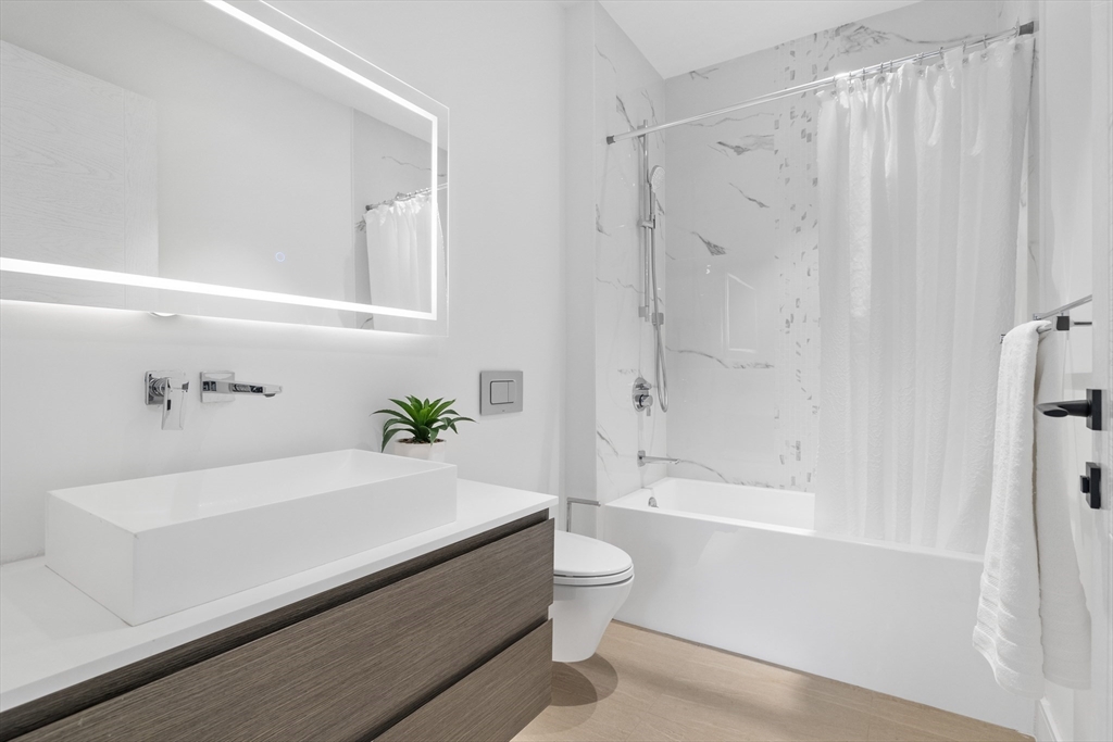 69 Walnut Street, Unit 10A Brookline, MA 02445 - Photo 11 of 17 a bathroom with a sink a toilet and bathtub