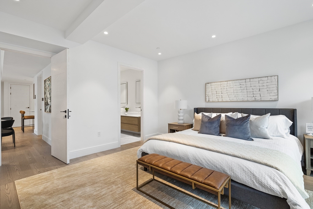 69 Walnut Street, Unit 10A Brookline, MA 02445 - Photo 13 of 17 a bedroom with a bed and a chandelier