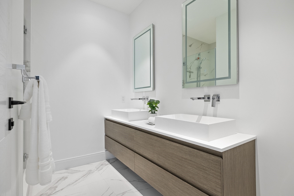 69 Walnut Street, Unit 10A Brookline, MA 02445 - Photo 14 of 17 a bathroom with a sink and a mirror