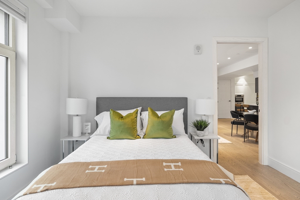 69 Walnut Street, Unit 10A Brookline, MA 02445 - Photo 17 of 17 a bedroom with a bed lamps and chairs