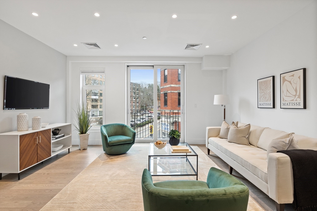 69 Walnut Street, Unit 10A Brookline, MA 02445 - Photo 3 of 17 a living room with furniture and a flat screen tv