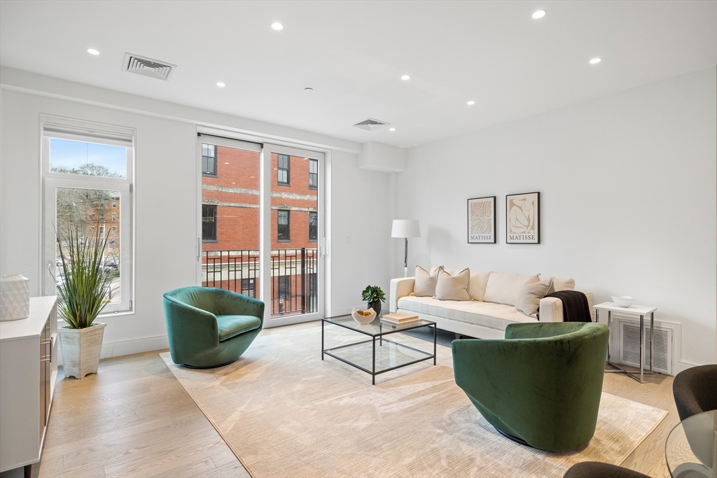 69 Walnut Street, Unit 10A Brookline, MA 02445 - Photo 4 of 17 a living room with furniture and a potted plant