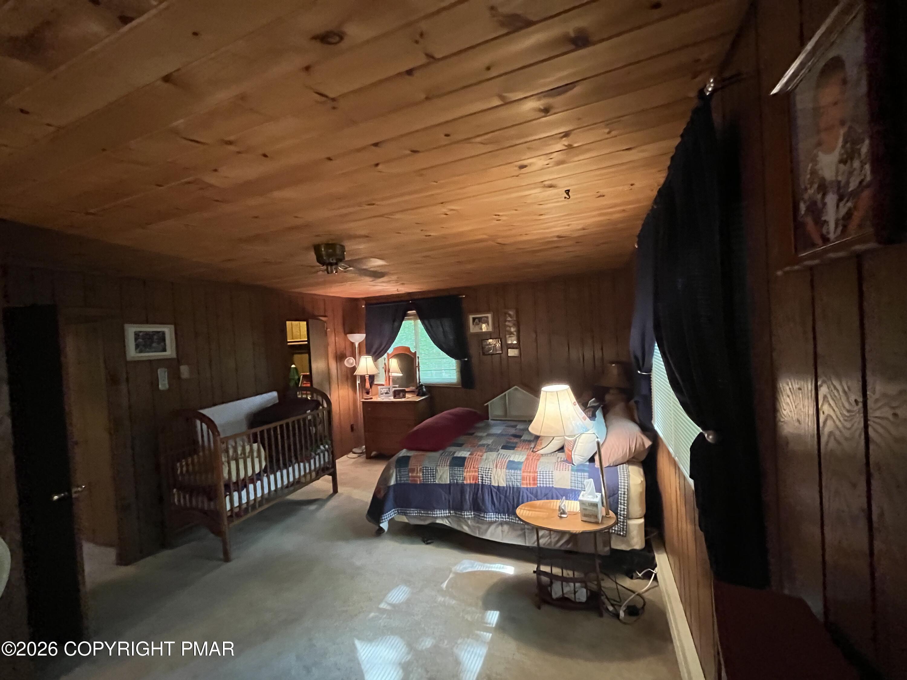 5970 Decker Road Bushkill, PA 18324 - Photo 24 of 26 a bedroom with furniture and a lamp