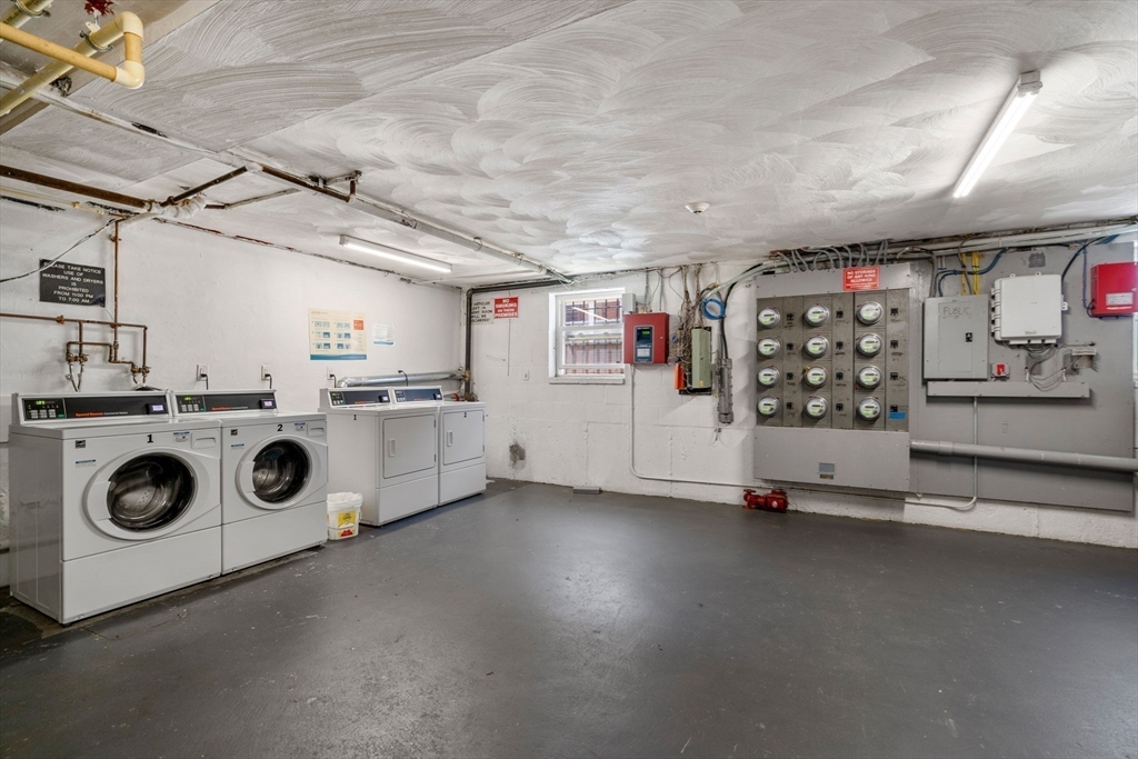 1105 Lexington Street, Unit 41 Waltham, MA 02452 - Photo 8 of 9 a utility room with lots of wooden cabinets