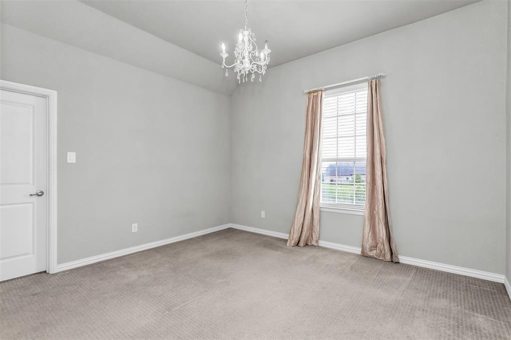6333 Hall Road Frisco, TX 75034 - Photo 30 of 38 Neutral-toned room featuring a crystal chandelier, a window with horizontal blinds, and light gray wall paint