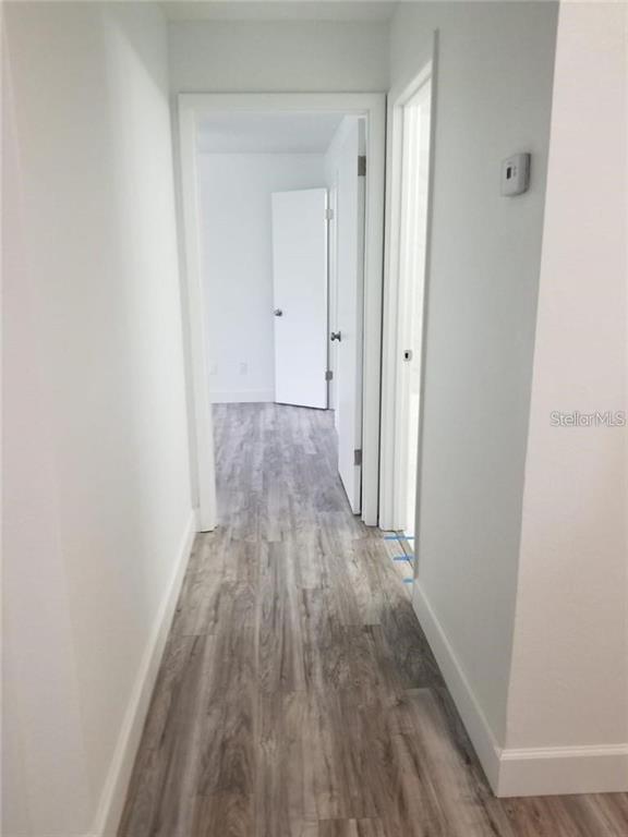 236 Afton Square, Unit 201 Altamonte Springs, FL 32714 - Photo 14 of 42 a view of a hallway with wooden floor