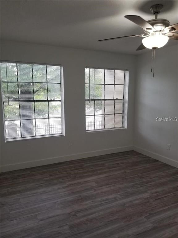 236 Afton Square, Unit 201 Altamonte Springs, FL 32714 - Photo 15 of 42 a view of an empty room with wooden floor and a window