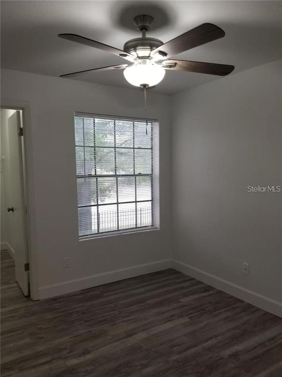 236 Afton Square, Unit 201 Altamonte Springs, FL 32714 - Photo 17 of 42 an empty room with wooden floor chandelier fan and windows