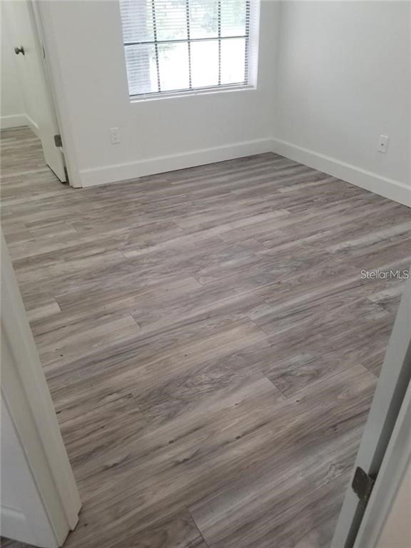 236 Afton Square, Unit 201 Altamonte Springs, FL 32714 - Photo 18 of 42 wooden floor in an empty room