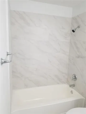 a bathroom with a toilet a sink and bathtub