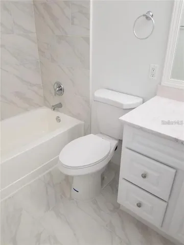 a living room with lots of furniture hardwood floor and a ceiling fan