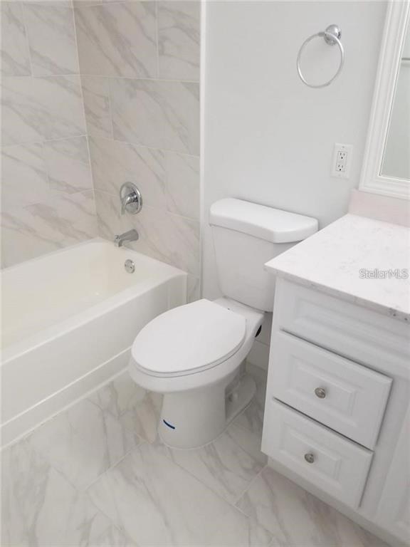 236 Afton Square, Unit 201 Altamonte Springs, FL 32714 - Photo 22 of 42 a bathroom with a toilet a sink and bathtub