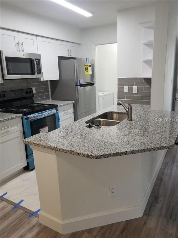236 Afton Square, Unit 201 Altamonte Springs, FL 32714 - Photo 8 of 42 a kitchen with granite countertop a sink and steel stainless steel appliances