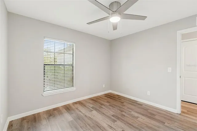 a view of a big room with wooden floor and windows in a room