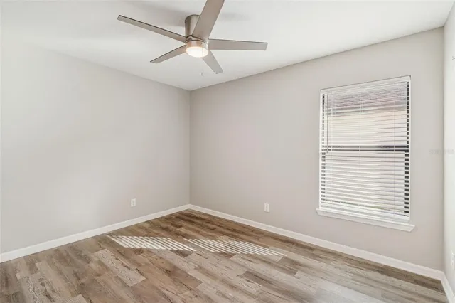 a view of a room with wooden floor and a bathroom