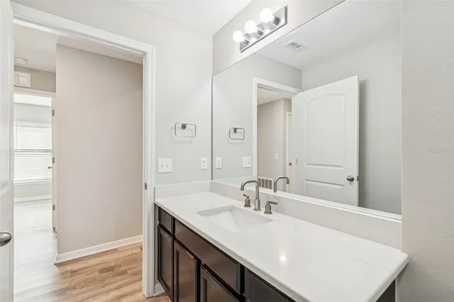a kitchen with granite countertop a refrigerator stove and microwave