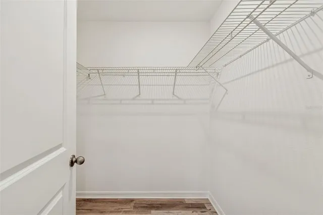 a view of kitchen with granite countertop cabinets and refrigerator