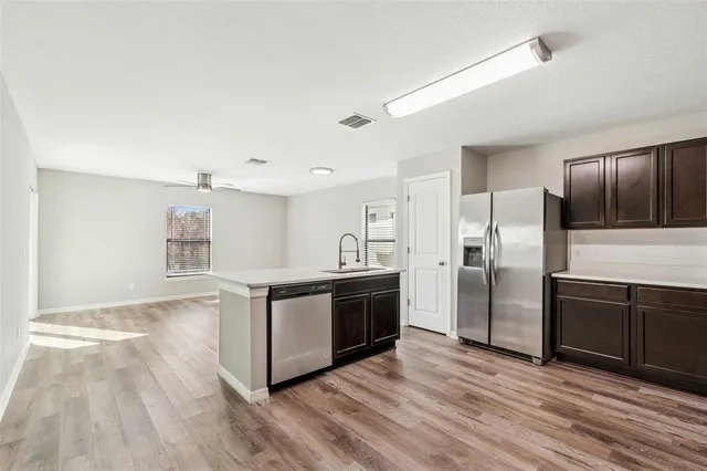 an aerial view of residential houses with outdoor space and ocean view