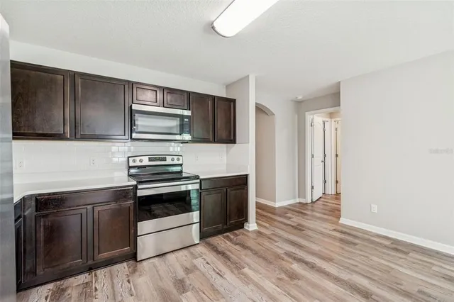 a aerial view of a house with swimming pool and a yard