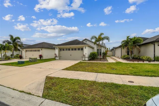 a view of a hallway with wooden floor and a bathroom