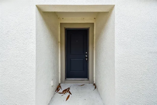 a view of a hallway with wooden floor and entryway