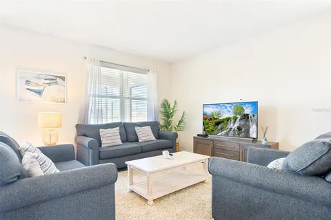 a living room with furniture and flower pot