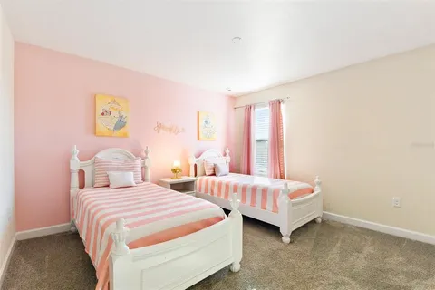 a bedroom with a bed and a lamp