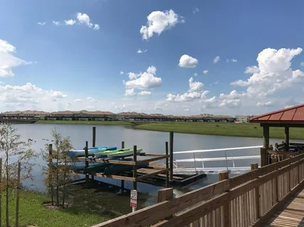 a view of a house with pool and sitting area