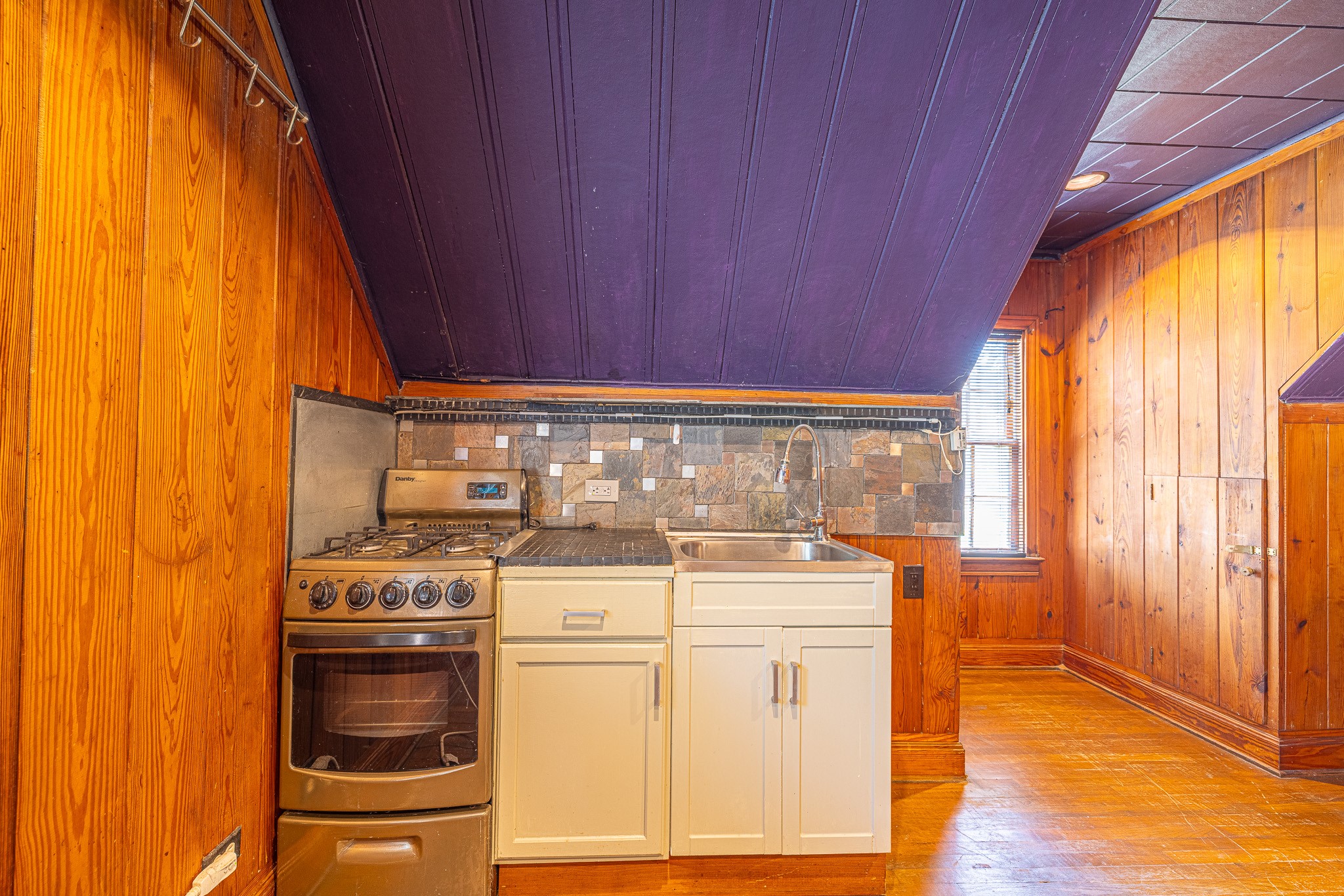 8548 Findlay Street Houston, TX 77017 - Photo 33 of 50 a kitchen with a stove and a wooden floor