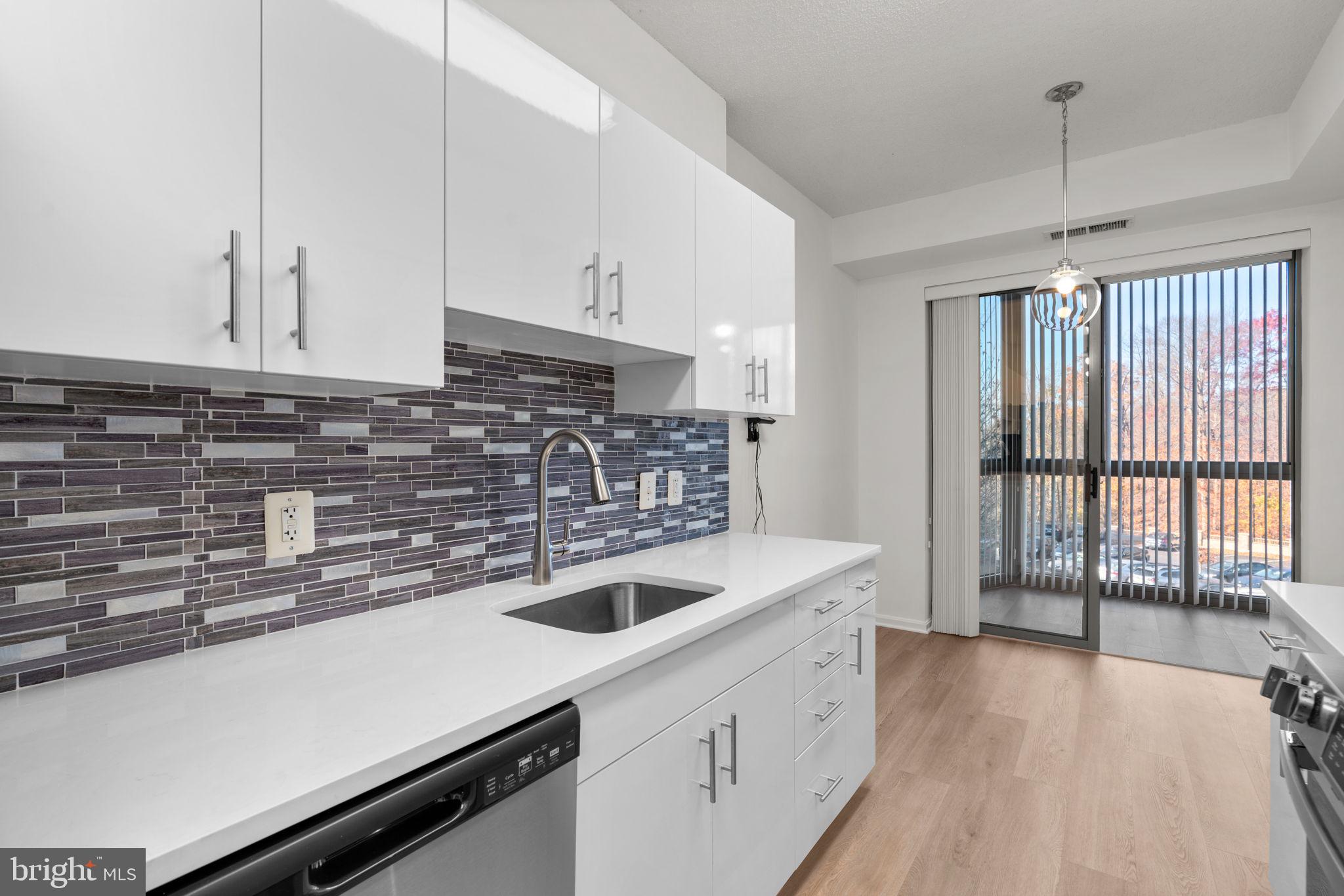 2901 South Leisure World Boulevard, Unit 233 Silver Spring, MD 20906 - Photo 11 of 43 a kitchen with a sink and cabinets