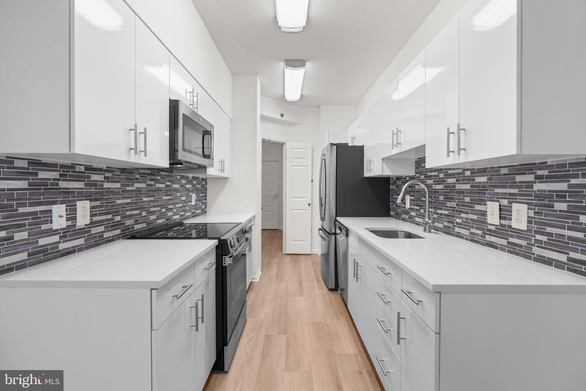 2901 South Leisure World Boulevard, Unit 233 Silver Spring, MD 20906 - Photo 12 of 43 a kitchen with a sink stove and refrigerator
